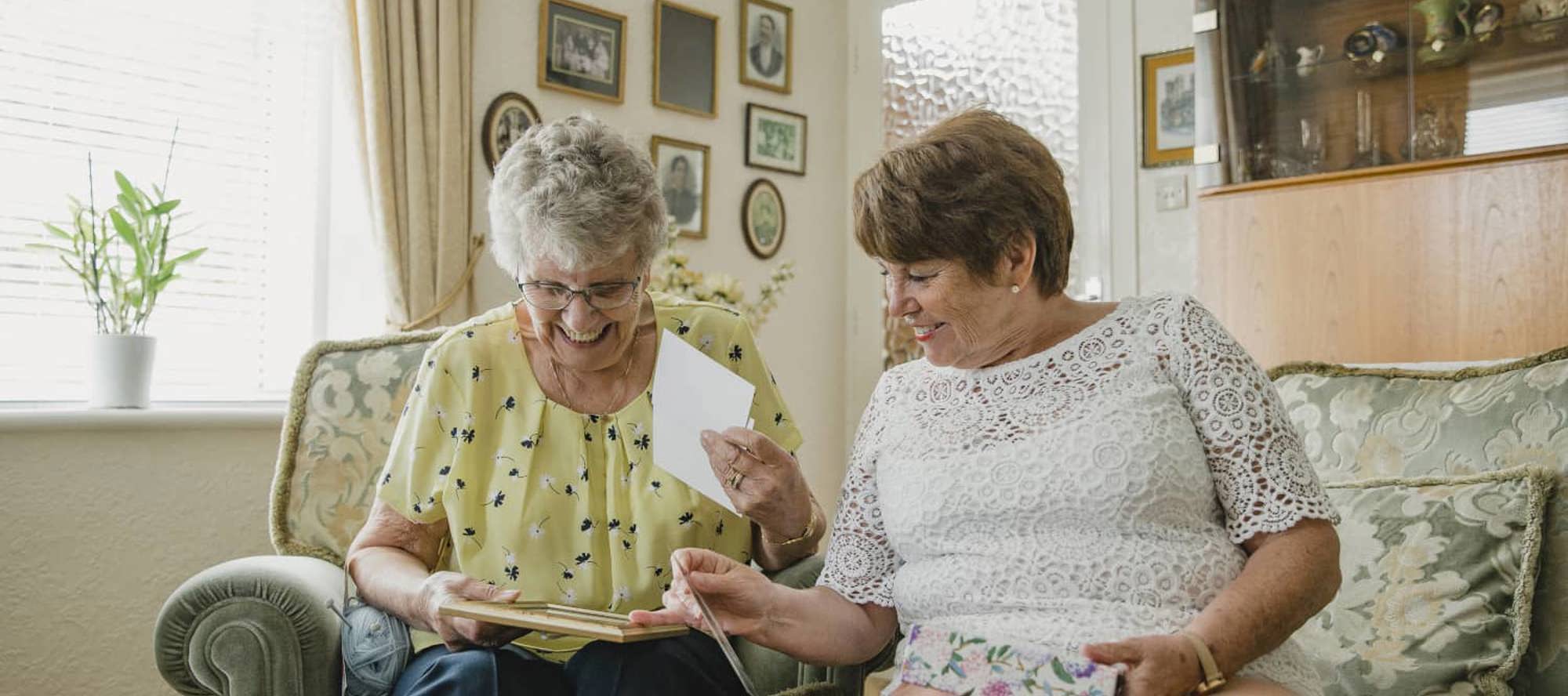 two adults sat next to each other on a sofa