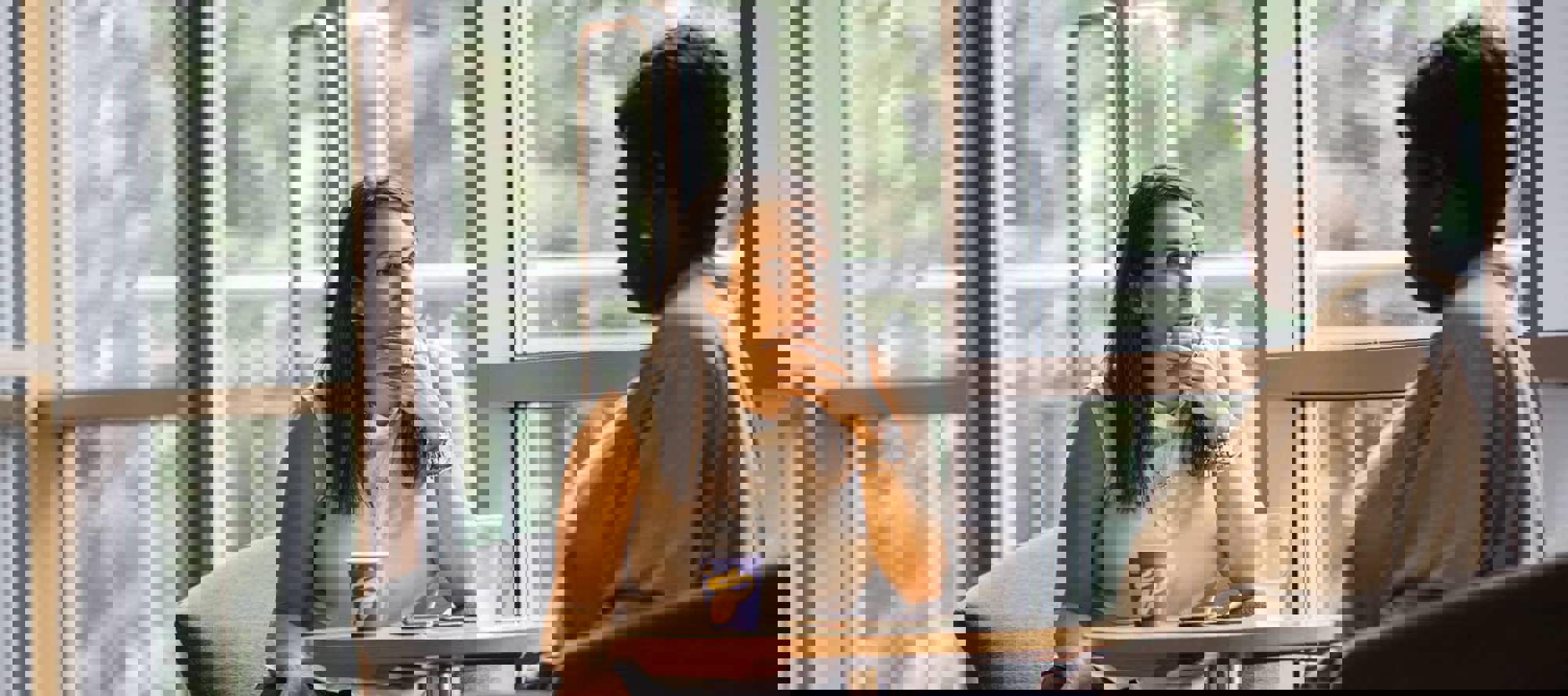 two people sat at a table talking